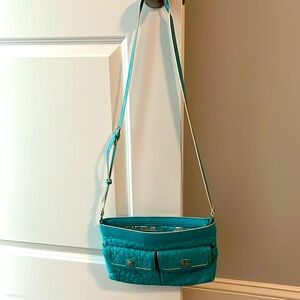 Crossbody purse in turquoise color by Vera Bradley.